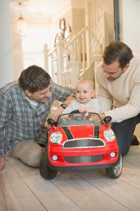 Male Gay Parents And Baby Son Playing With Toy Car Stock Image F018 5590 Science Photo Library