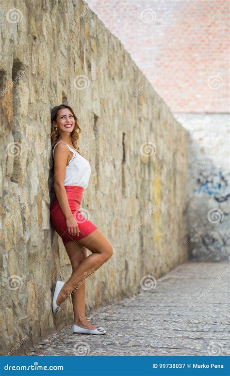 Beautiful Young Woman Leaning Against A Wall Stock Image Image Of