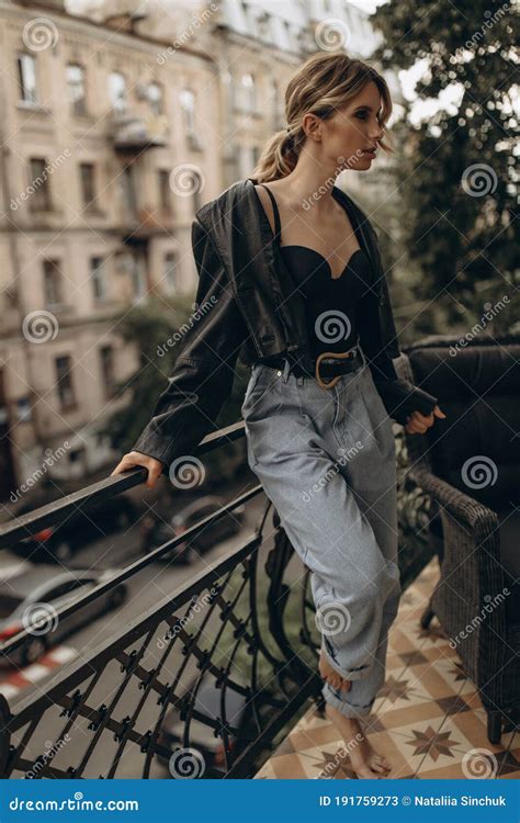 Stylish Fashionable Blonde Woman With Smoky Eye Makeup In Jeans