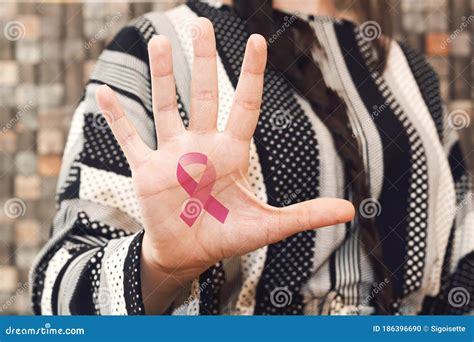 A Pink Ribbon Painted In The Palm Of A Young Caucasian Woman Stock