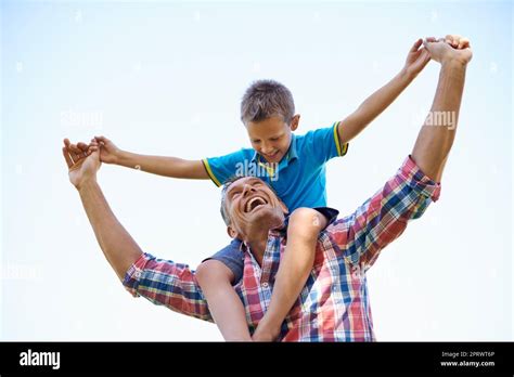 Dads Pride And Joy A Low Angle Shot Of A Happy Father Carrying His