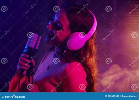 Girl Singing in Microphone stock photo. Image of girl - 300505046