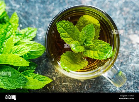 Tasty mint tea. Mint leaves and tea cup Stock Photo - Alamy