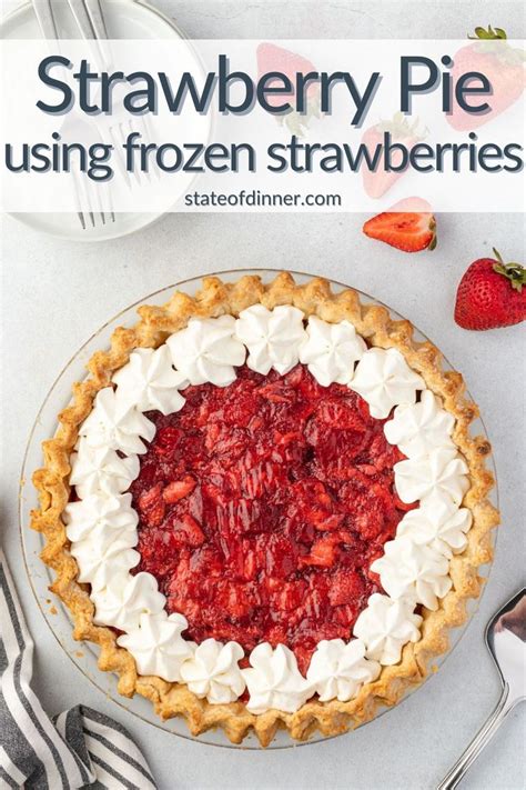 A Strawberry Pie Sitting On Top Of A White Table Next To Silverware And