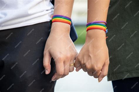 Premium Photo Hand Of Lgbt Women Holding Together With Rainbow Ribbon