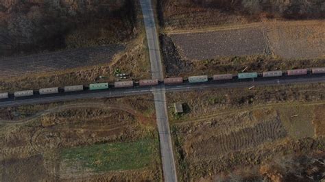 Premium Photo Top View Freight Train Passing Railway Crossing Aerial