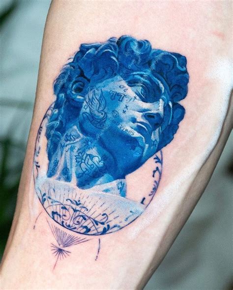 Creative Arm Tattoo with Blue Ink Face Image