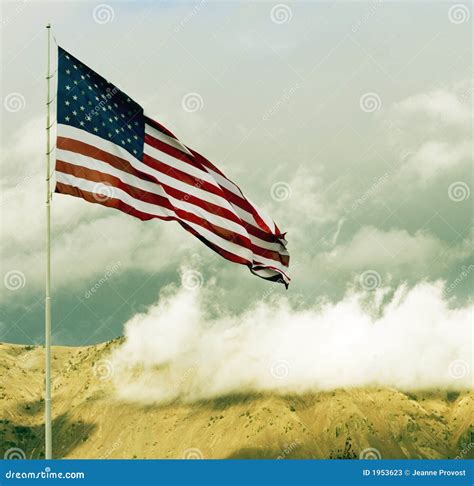 American Flag Flying Over Hilltop With Clouds Stock Photos Image 1953623