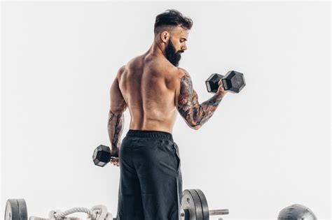 Premium Photo Muscular Athlete Bodybuilder Man With A Naked Torso Workout With Dumbbell