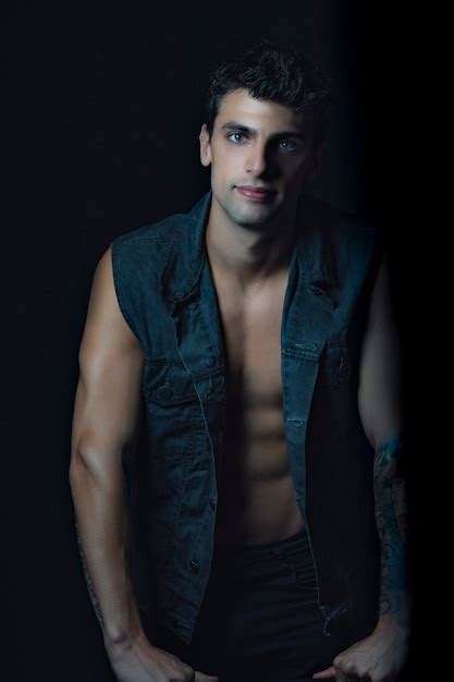 Premium Photo Handsome Man Standing Looking At The Camera Wearing A Jean Vest And Naked Torso