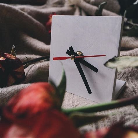 a clock made out of paper with black and red hands