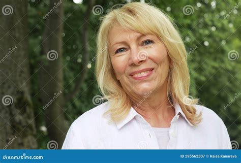 Beautiful Blonde Woman Of Sixty Years Old In A Summer Park Close Up Portrait The Lady Smiles