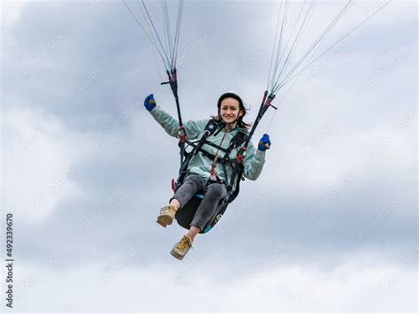 A girl flying a paraglider Stock Photo | Adobe Stock