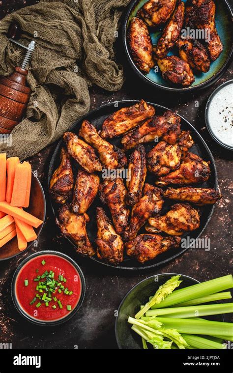 Grilled Spicy Chicken Wings Served With Tomato And Yogurt Dips Celery