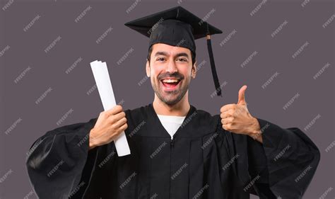 Premium Photo Man On His Graduation Day University Giving A Thumbs Up