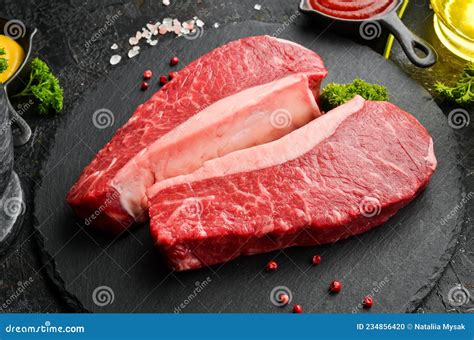 Two Fresh Raw Marble Meat Black Angus Ribeye Steak With Spices On A