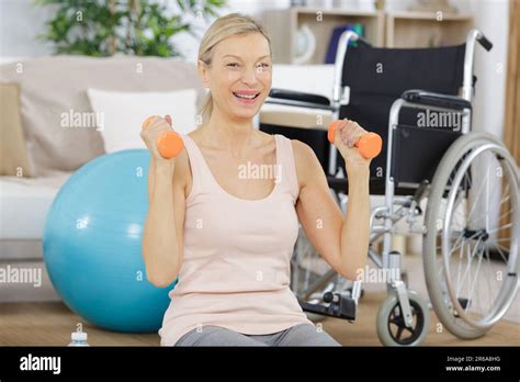 Happy Mature Woman Exercising With Dumbbells Stock Photo Alamy