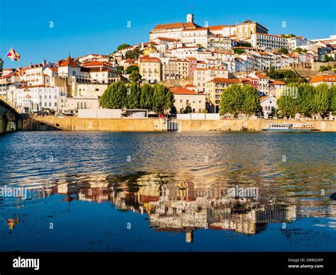 Stunning skyline of Coimbra reflected in Mondego river, Portugal Stock ...