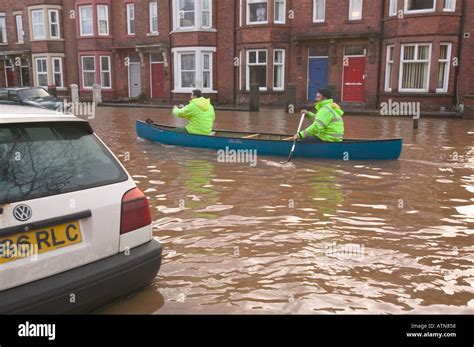 Rescue Workers Canoe Down Warwick Road In The Carlisle Floods Stock