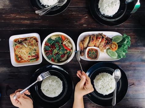 People Eating Thai Food On A Brown Wooden Table On A Holiday. Stock ...