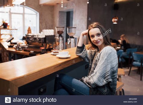 Attractive Young Woman Sitting Indoor In Urban Cafe Cafe City