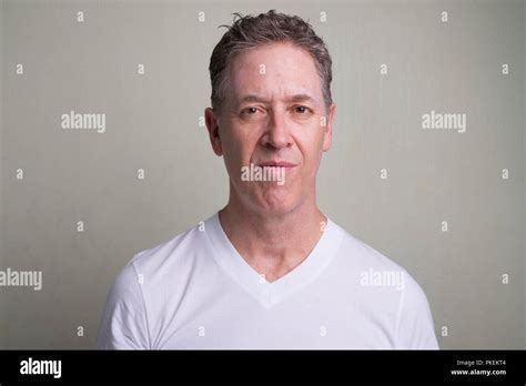Portrait Of Mature Man With Gray Hair Against White Background Stock Photo Alamy