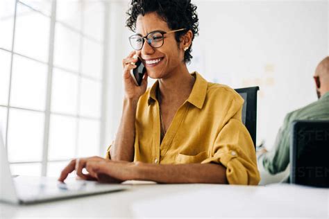 Female Accountant Talking To Her Clients On The Phone She Makes Calls