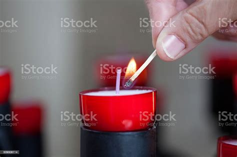 Female Mature Woman Burning Candle Light In Church Stock Photo