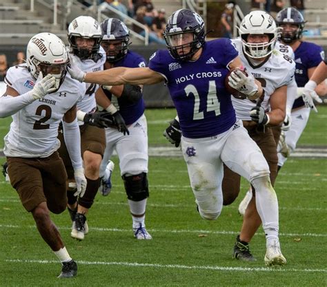 Holy Cross Football Raises High Patriot League Trophy For Fourth