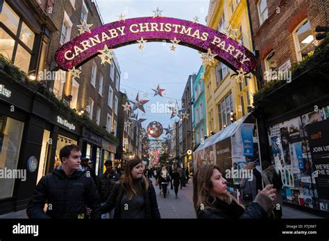 A Woman Taking Photos Of The Christmas Decorations In Carnaby Street