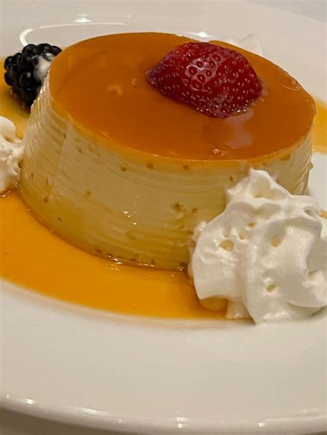 Delicious Flan Dessert With Whipped Cream And Orange Sauce