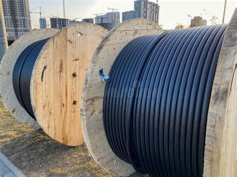 Large Spool With Black Thick Electrical Wire Or Cable Wooden Coil With