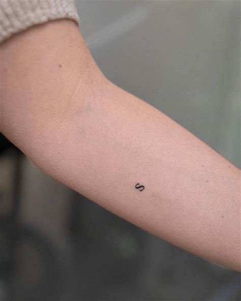 Minimalistic Style Tattoo Of The Letter S Located On