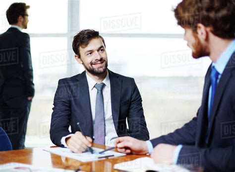 Two Businessmen Talking In Office Stock Photo Dissolve