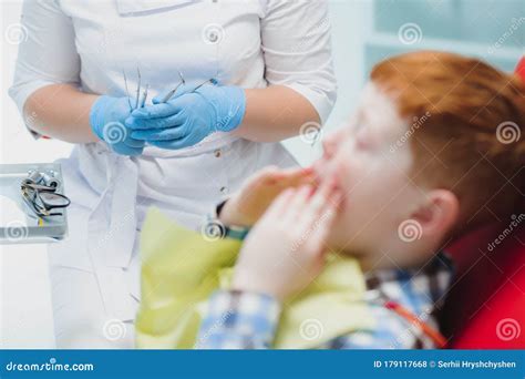 Portrait Of A Dentist Holding Dental Instruments In His Hands In The