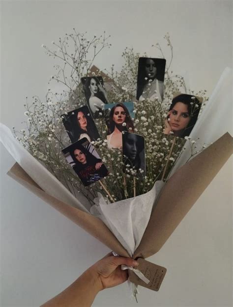 Someone Is Holding A Bunch Of Flowers With Pictures On It