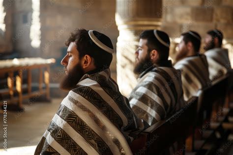 Jewish men praying in a religious orthodox synagogue adorned with