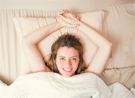 Free Photo High Angle View Of Smiling Young Woman Lying On Bed Looking Up