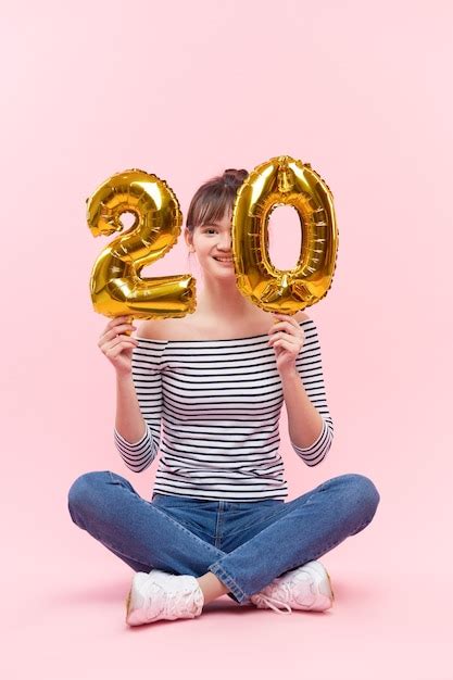 Premium Photo Woman Holding Inflatable Balloons In The Form Of Twenty