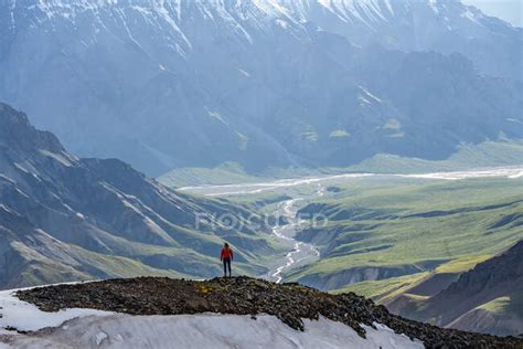 Woman Exploring The Rugged Mountains Of Kluane National Park And