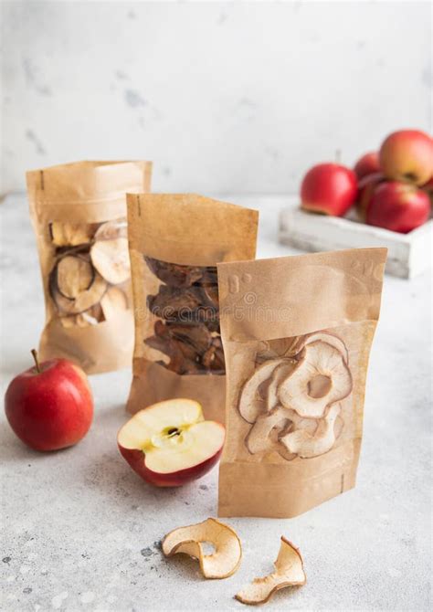 Packages Of Assorted Sweet Dried Apple Chips And Slices On Light