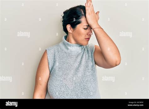 Plus Size Brunette Woman Wearing Casual Clothes Surprised With Hand On Head For Mistake