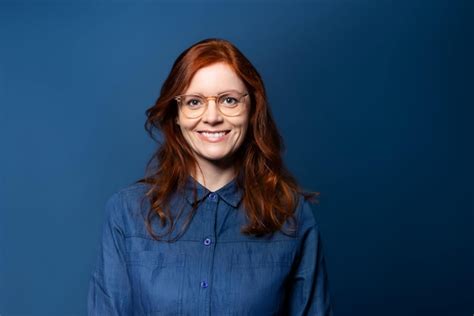Premium Photo Portrait Of A Smiling Mature Woman With Red Hair On Blue Studio Background