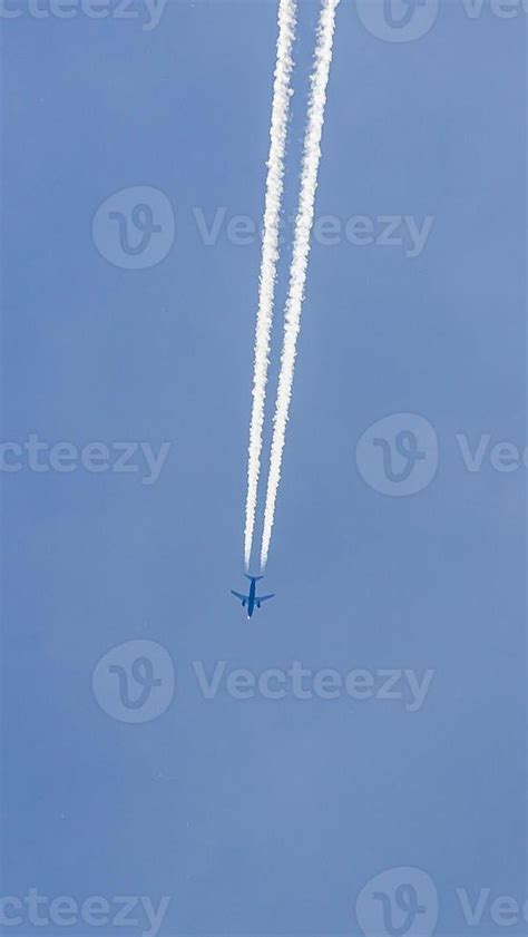 Two Engined Airplane During Flight In High Altitude With Condensation