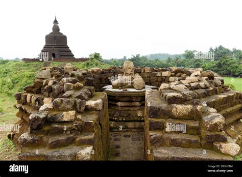 A Ruined Stone Stupa With Damaged Buddha Statue In The Centre With