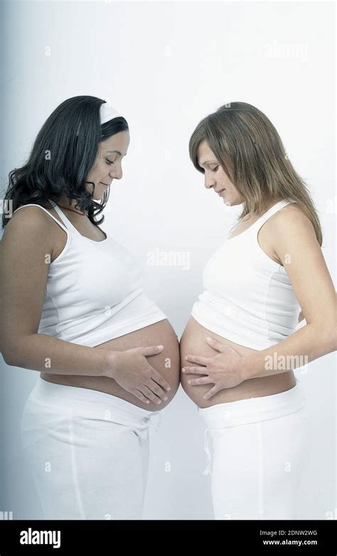 Two pregnant women touching stomachs Stock Photo - Alamy