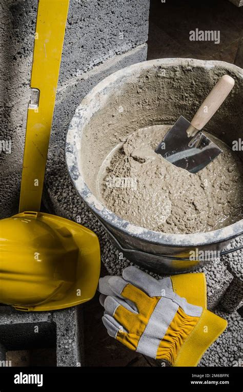 Tools For Bricklayer Bucket With A Solution And A Trowel Close Up