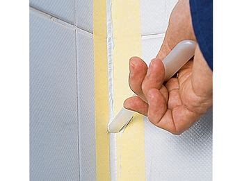 A Person Is Marking The Corner Of A Wall With A Marker On It S Side