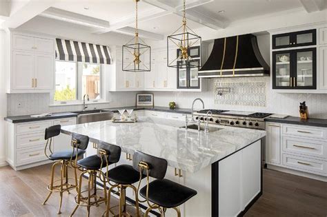 Gold And Black Kitchen With Thick White Marble Countertops Contemporary