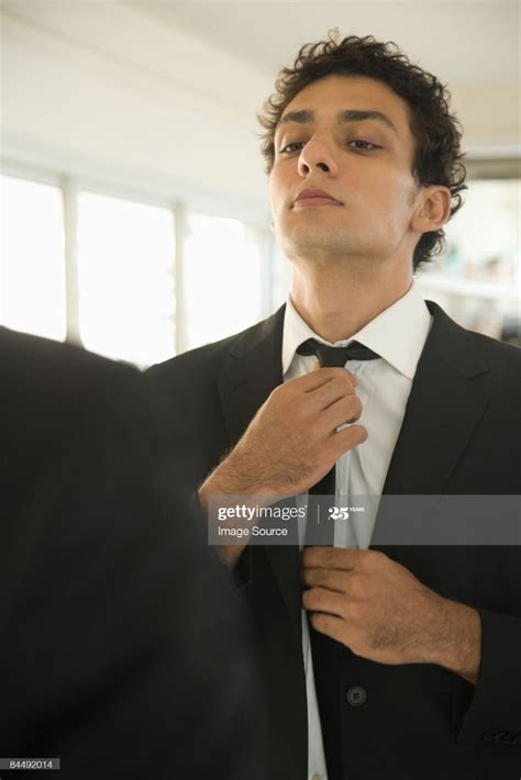 Man Adjusting Tie In Mirror Pose Reference Photo Pose Reference Poses